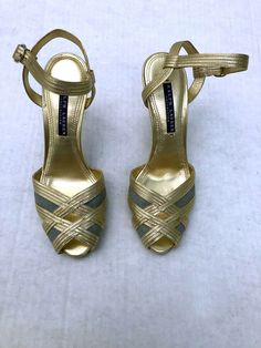 Very Chic Ralph Lauren Collection strappy gold high heel sandals. Gold metallic leather with ice blue linen inset. Worn once. Originally 385. size 7B. 80s / 90s. Padded innersole. Overall in very good condition. Some very minor scuffs on side of one shoe-shown in photo. Generally hard to see unless this was pointed out. Sold as-is. Please see measurements for proper fit and compare to your other shoes as all sales are final. length of sole  9 width of sole 3 heels 3.5 Terms and Info regarding it 90s Heels, Gold High Heel Sandals, Foot Games, Sandals Gold, Open Toe Heels, Silver Sandals, Ralph Lauren Collection, Shoe Show, Metallic Leather