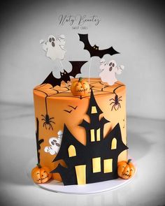 a cake decorated with halloween decorations and bats