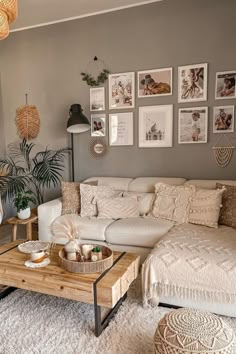 a living room filled with lots of furniture and pictures on the wall above it's coffee table