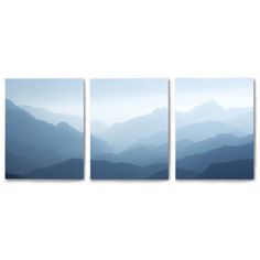 three blue mountains are shown in this wall art print on the white wall behind them