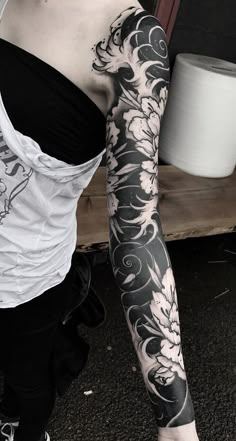 a woman with black and white tattoos on her arm