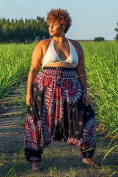 Part of our plus size range, these black Lotus pants are super comfortable 2-in-1 harem pants which double as a jumpsuit. They are versatile, practical and easy to style.PatternThe print is inspired by a Thai spiritual symbol, the lotus flower. Dual color petals adorn the waist and lower legs down to the anklets. The pattern is bold yet projects a calm and tranquil feel.100% Vegan & FairtradeAs with all our pants, these lotus pants are made from vegan-friendly material. Bamboo rayon has a unique Plus Size Boho Grunge Outfits, Flower Pants Outfit, Harem Pants Diy, Spiritual Outfits, Plus Size Hippie Fashion, Harem Pants Outfit, Plus Size Harem Pants, Plus Size Hippie, Boohoo Style