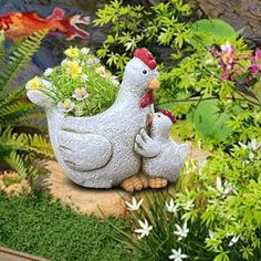 two chickens are in the garden with flowers