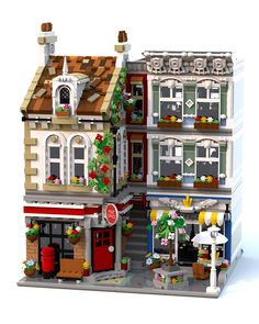 a lego model of a building with christmas decorations on the front and side of it