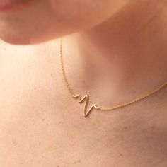 "Express your love with our dainty gold heartbeat necklace. Representing wisdom and compassion the heartbeat necklace makes a thoughtful gift that is suited for everyday wear. A great piece for layering your necklaces and bold enough to stand on its own. Our gold heart beat necklace is made of genuine 925 sterling silver with gold. * S I Z E: - 15\" + 1\" extender chain * ＤＥＴＡＩＬＳ: - 925 Sterling Silver with gold - Ships next business day - Made in Oakville, ON. * C A R E: - remove when swimming, Heartbeat Necklace Gold, Heartbeat Jewelry, Heartbeat Necklace, Evil Eye Necklace Gold, Heart Beat, Evil Eye Necklace, Simple Jewelry, Minimalist Necklace, Eye Necklace