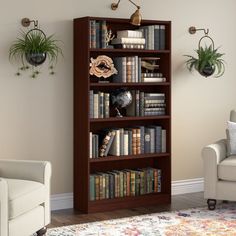 a living room with a couch, chair and book shelf filled with lots of books