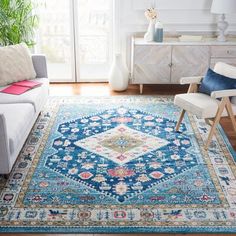 a living room filled with furniture and a blue rug