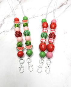 three watermelon and melon beaded necklaces on white marble counter top