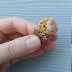 This mixture of pyramid spiral Sea shells, copper seed beads and golden yellow polymer clay come together to create a truly unique fashion ring.  I afixed them to a copper filigree ring band which is adjustable, yet pretty. The ring speaks of ocean treasures and blazing hot beach days. 🌊 I found the seashells here in Santa Cruz, California on one of our beaches. The golden clay hugs the shells mimicking golden sands. Stun them with this one-of-a-kind artistic fashion ring.  Quality materials, lead and nickel free ring band.  I will box and ship this ring within 3 business days of your order. Please specify if it is a gift at checkout. Love and light!  Mountain Ocean Spirit Unique Handmade Shell For Jewelry Making, Handmade Shell For Jewelry Making, Bohemian Polymer Clay Jewelry For Beach, Seashell Ring, Beach Rings, Pretty Headbands, Artistic Fashion, Clay Ring, Ocean Treasures