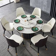 a marble dining table with six chairs around it