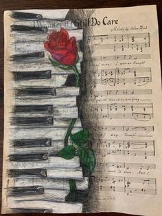 a drawing of a rose sitting on top of piano keys