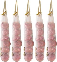 five bags filled with pink balls hanging from hooks