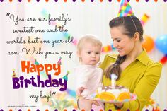 a woman holding a baby in front of a birthday cake with the words happy birthday on it