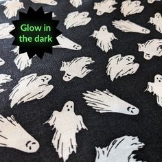 black and white ghost print fabric with glow in the dark text overlaying it