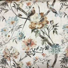 a white pillow with flowers and birds on it