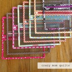 six different colored frames on a wooden table with the words crazy mom quilts written in them