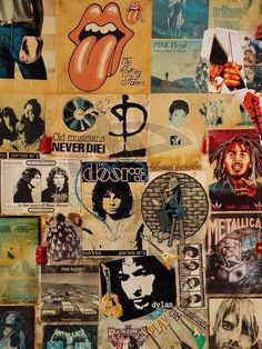 a wall covered in posters and stickers with the rolling stones on it's side