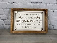 a wooden frame with a sign that says to all a good night not such bed and breakfast milk and cookies served nightly