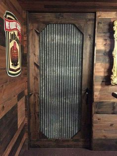 an old wooden door in a room with wood paneling