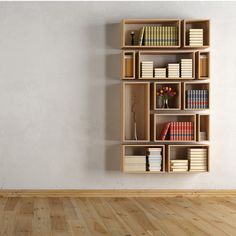 an empty room with bookshelves on the wall and wood flooring in front of it