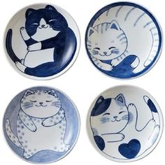 four blue and white plates with cats on them