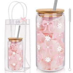 a glass jar filled with pink and white candies next to a clear container with straws in it