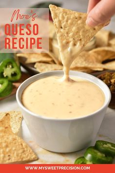 a person dipping quesadilla into a white bowl with tortilla chips