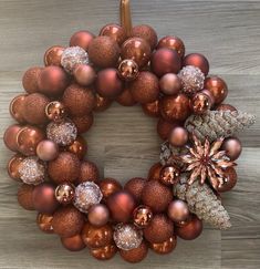 a christmas wreath made out of ornaments on a table