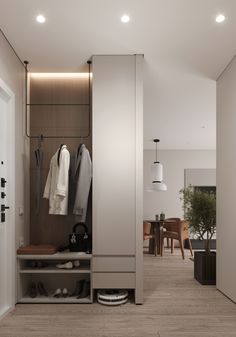 an open closet with clothes hanging on the wall