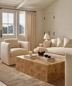 a living room with two couches and a coffee table in front of a window