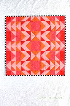 an orange and pink piece of fabric on a white surface