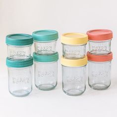 six mason jars with lids are lined up