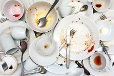 dirty dishes and utensils are piled on top of each other in this image