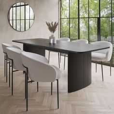 a dining room table with chairs around it