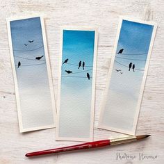 three watercolor cards with birds sitting on an electric wire and one has a red pen