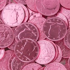 a pile of pink colored coins sitting on top of each other