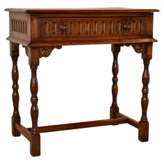 an old wooden table with carvings on the top and bottom shelf, isolated against a white background