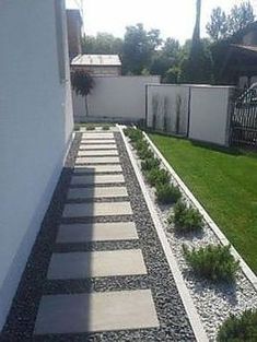 a garden with grass and rocks in the middle