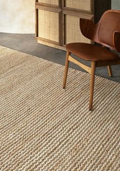 a wooden chair sitting on top of a rug