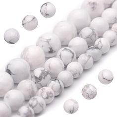 white marble beads with black spots on them