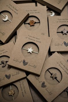 many different types of earrings are arranged in small boxes on the floor, some with holes cut out to make them look like they have been made from cardboard