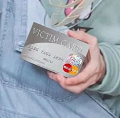 a person holding a credit card in their hand