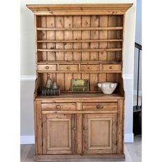 an old wooden cabinet with two bowls on top