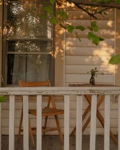 two wooden chairs sitting on the front porch