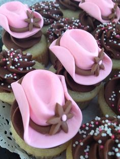 pink and brown decorated cookies with hats on them