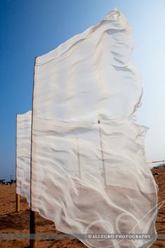 there is a large white sheet on the beach