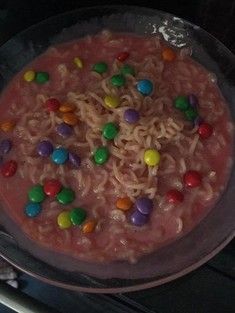 a bowl filled with noodles and candy beans