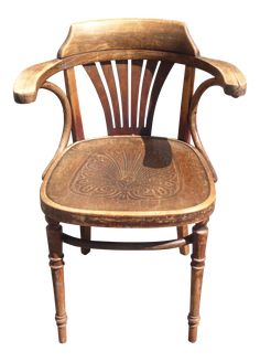 an old wooden chair with carvings on it's back and seat, against a white background