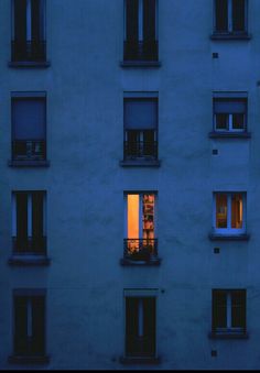 an apartment building with many windows at night