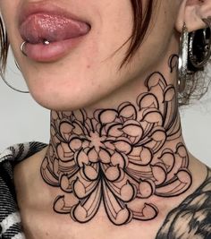 a woman wearing a black and white tattoo on her neck